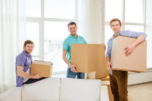 Professional movers handling business equipment during an office move