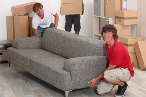 Local Stjohnswood furniture removals team loading sofas and cabinets into a van